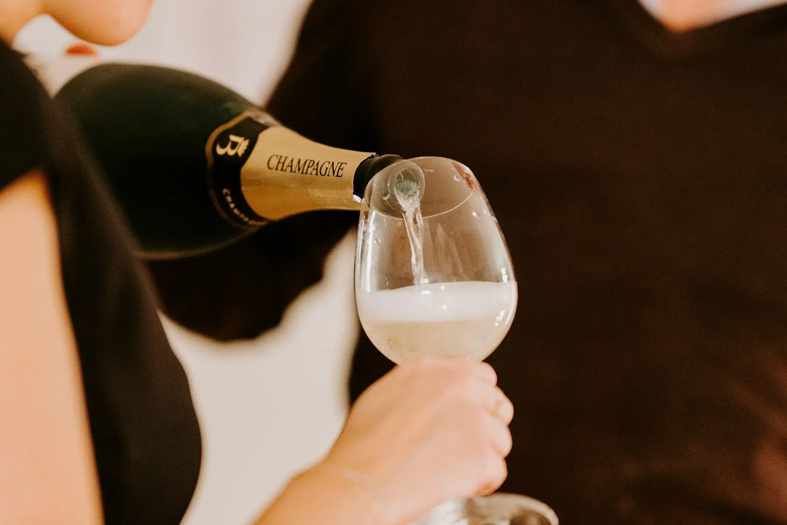 pouring bottle of champagne
